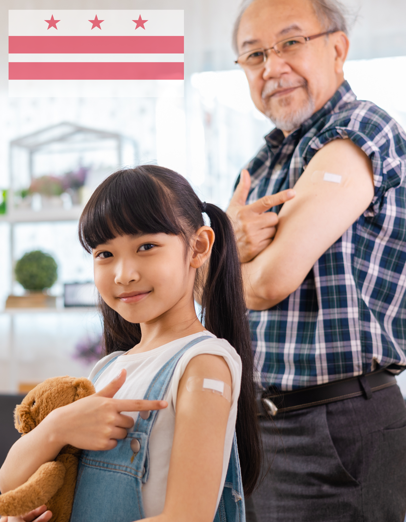 Two individuals smiling with bandaids and a DC flag